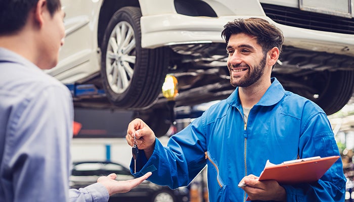 A technician handovering keys to customer